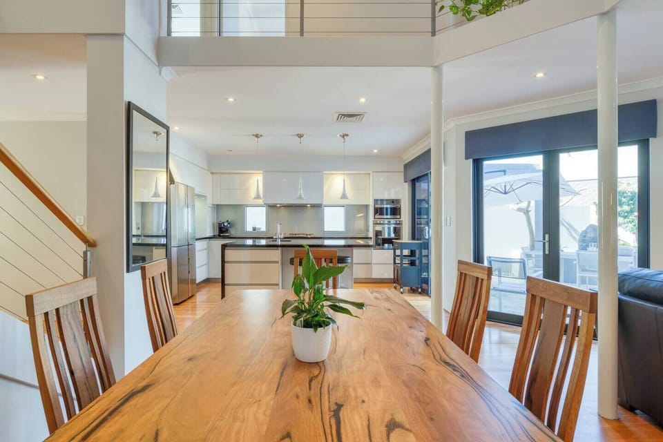 A light-filled, open-plan dining area includes an eight-seater table, while guests also have the option of enjoying casual meals at the kitchen island. 
