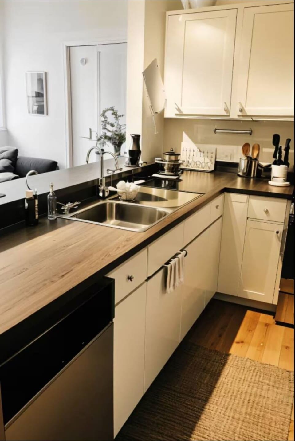 Large fully stocked kitchen with dishes, silverware, cooking ware.