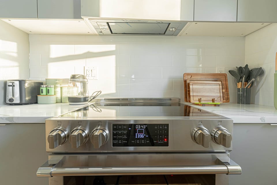 Modern electric cooktop and oven in sleek kitchen ready for home‑cooked meals.