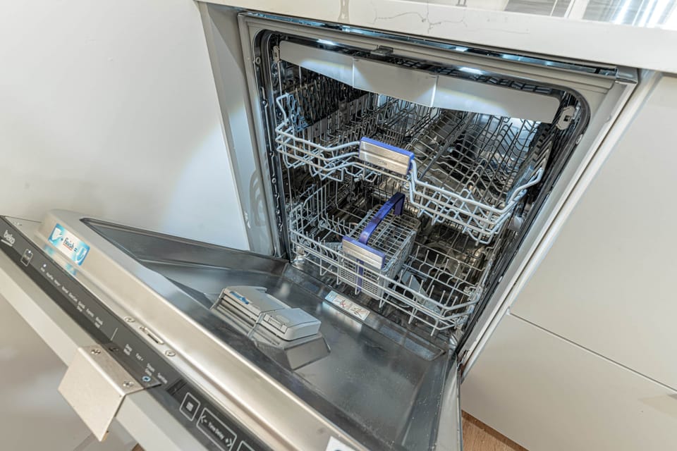 Built‑in dishwasher seamlessly integrated into cabinetry for effortless cleanup.