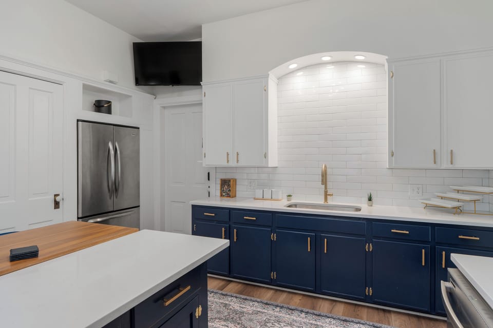 Open, airy kitchen layout with full-size fridge and ample storage.