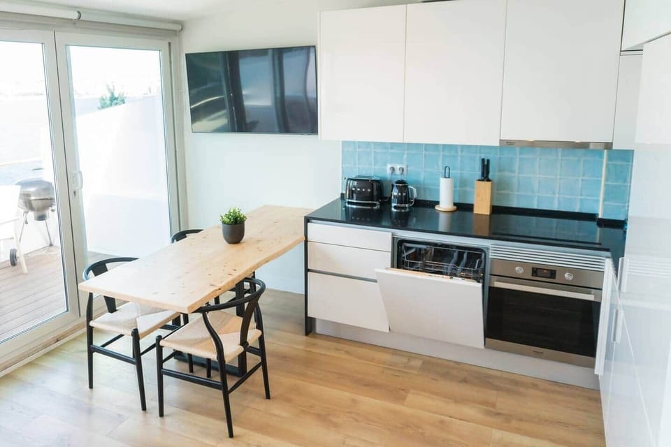 The kitchen comes fully equipped with an oven, dishwasher, and direct access to the BBQ on the balcony