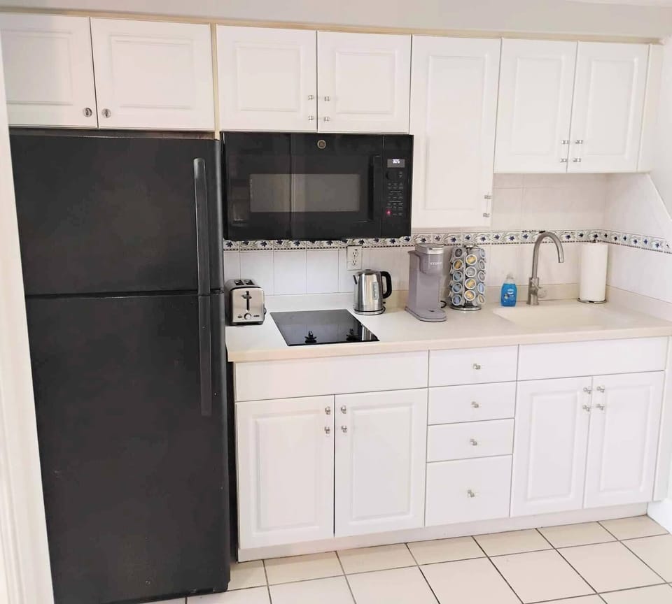Kitchen with full size fridge and all the cooking essentials