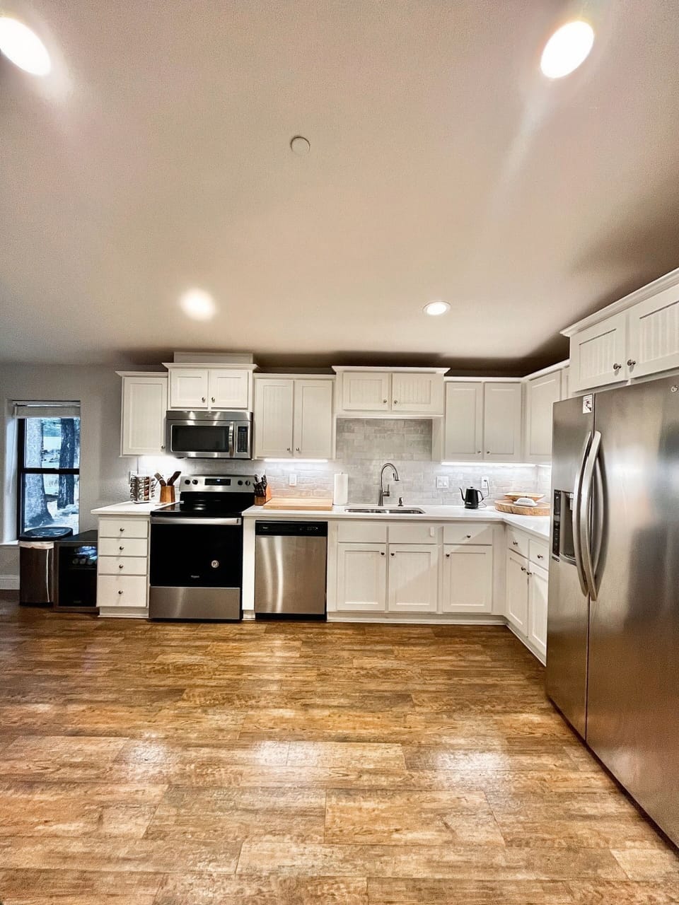 Modern updated kitchen with electric stove, microwave, and toaster oven.