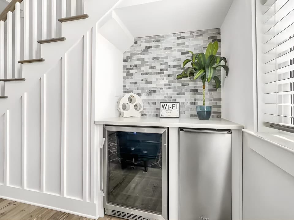 A dedicated beverage center under the stairs: featuring a wine cooler and mini-fridge.