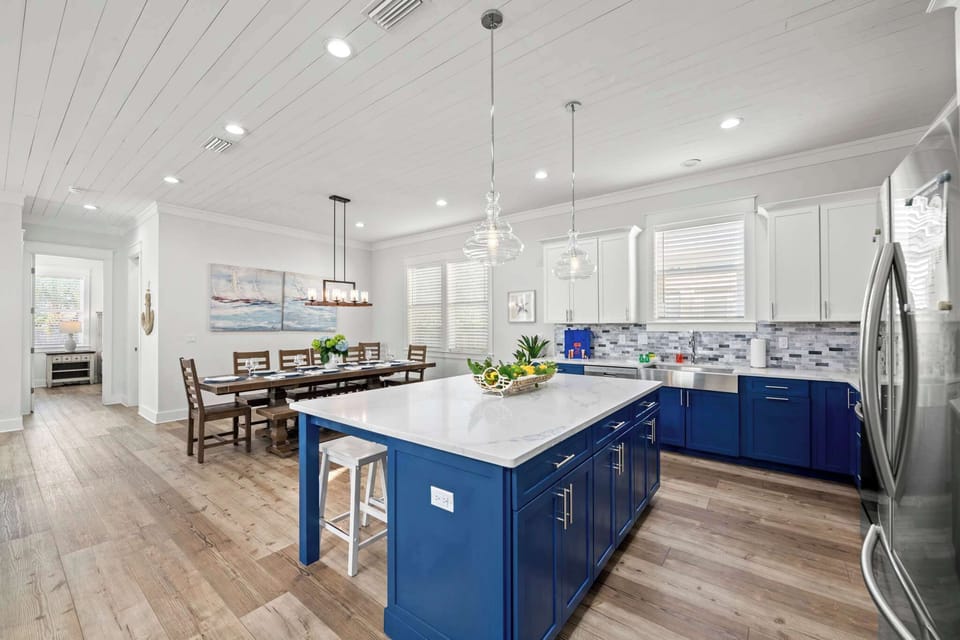 Fully equipped kitchen with stainless appliances, island, and bar seating