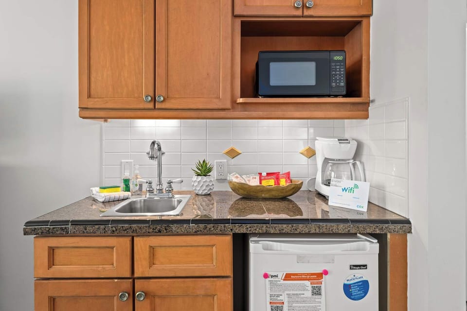 Compact kitchenette stocked for easy meal prep and refreshments