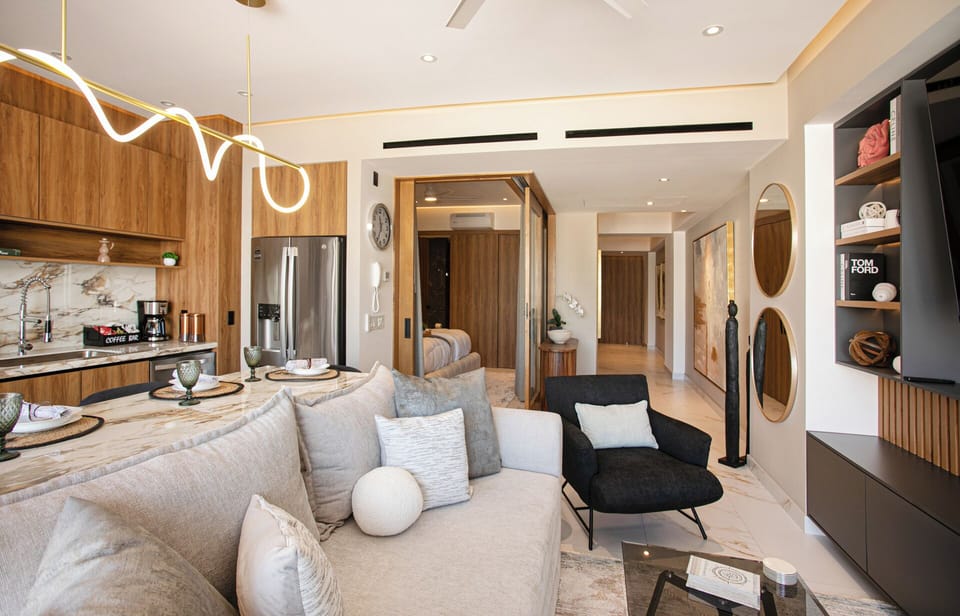 The modern living room includes a plush sleeper sofa that sleeps two comfortably, with their own private bathroom located just steps away along the hallway.