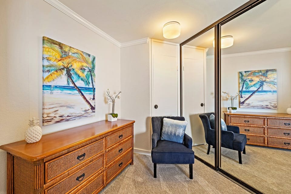 Ample drawer storage provided by the beautiful wooden dresser, plus a cozy chair perfect for reading or relaxing