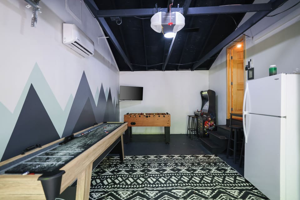 The Knotty Pine Cabin includes a garage game room with foosball & shuffleboard