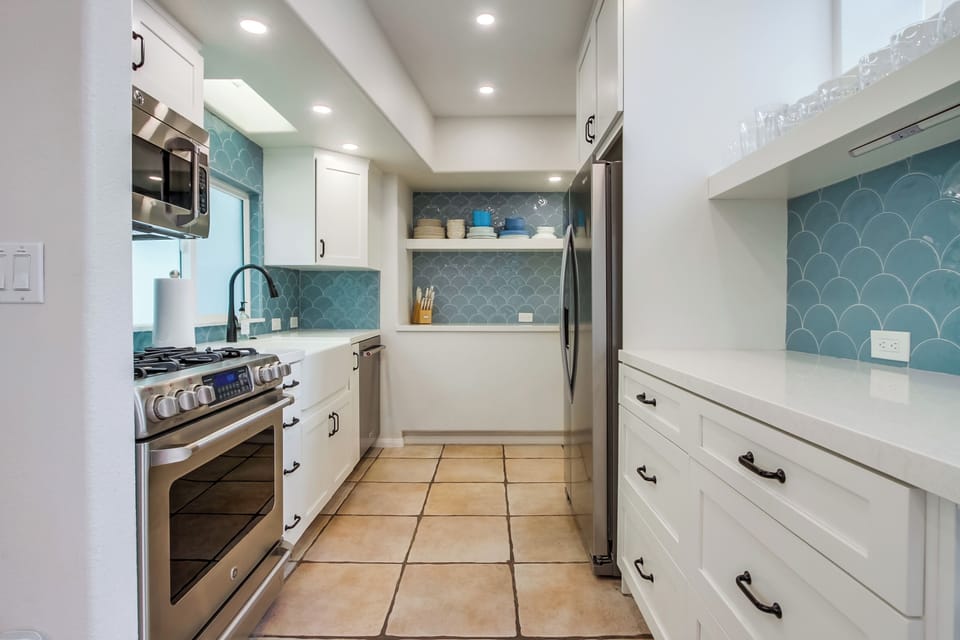 The kitchen is equipped with modern, stainless-steel appliances.