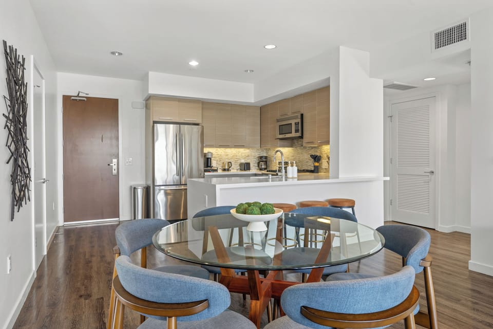 Enjoy a sunlit meal at the elegant dining table for six, open to the kitchen.