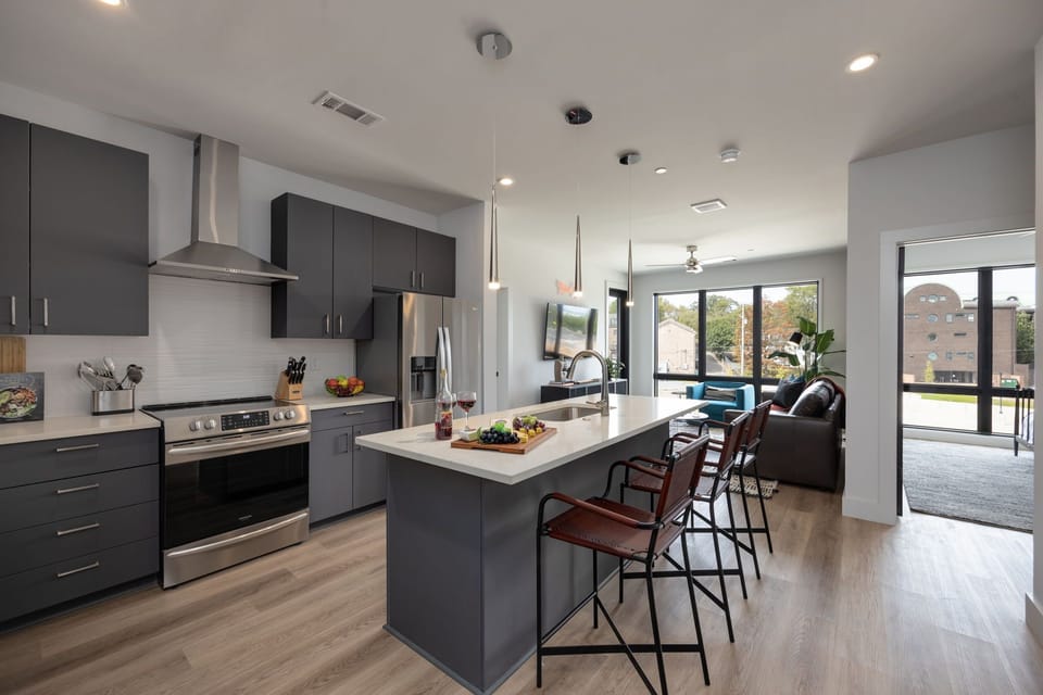 Unit 1: Fully equipped kitchen with brand-new stainless-steel appliances and a Kitchen island that offers ample counter space and bar seating.
