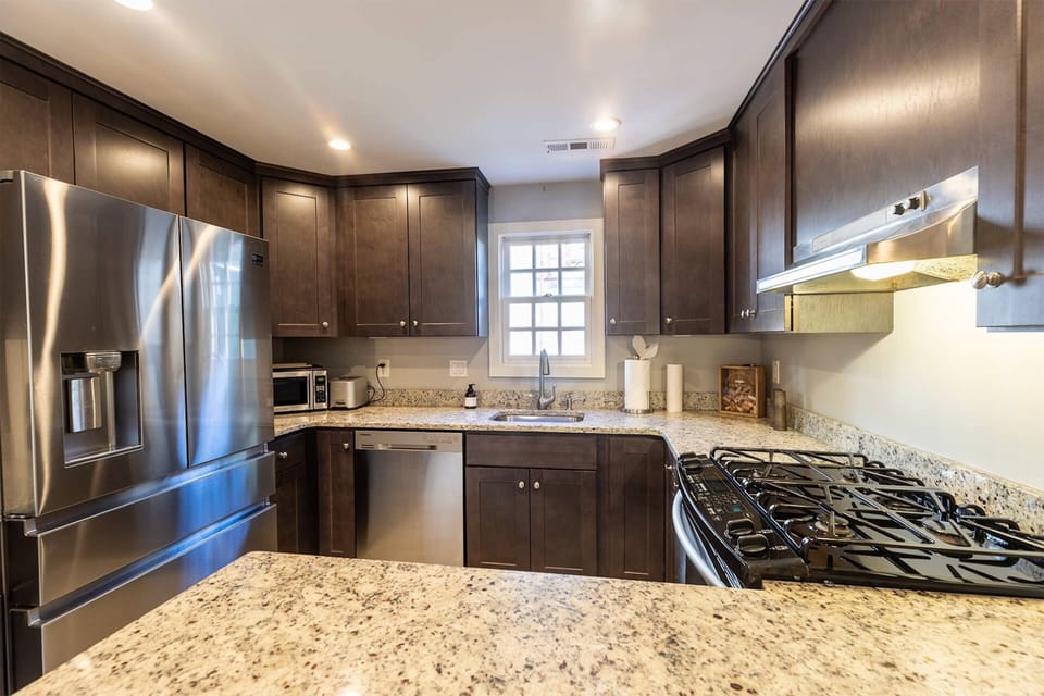 The gourmet kitchen was recently renovated to include all stainless steel appliances, including the chef's gas cooktop.