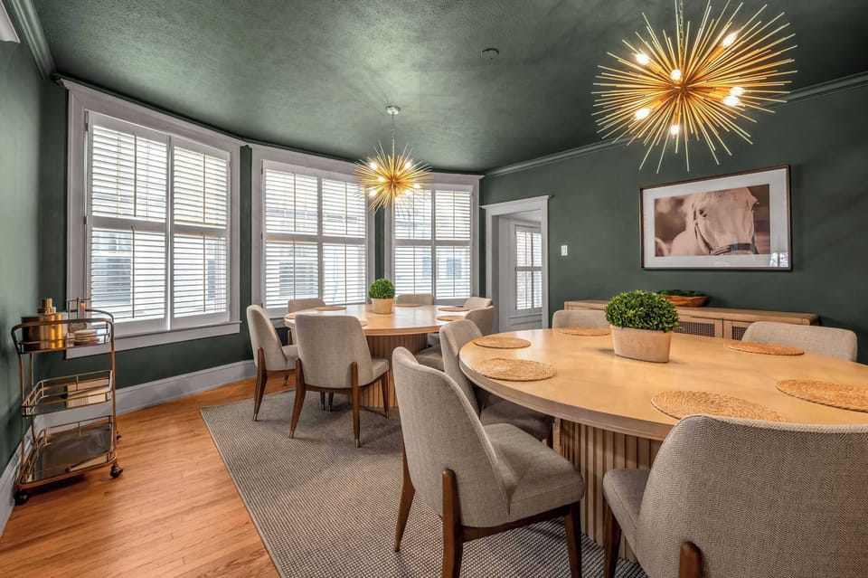 Grab a bottle off the bar cart before you sit down — this end of the dining room is made for the after dinner pour and the stories that come with it.