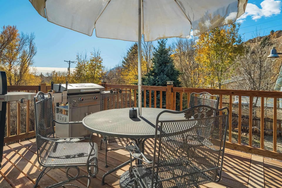 The upper deck includes a shaded outdoor dining setup, perfect for meals, morning coffee, or relaxing with open views.

