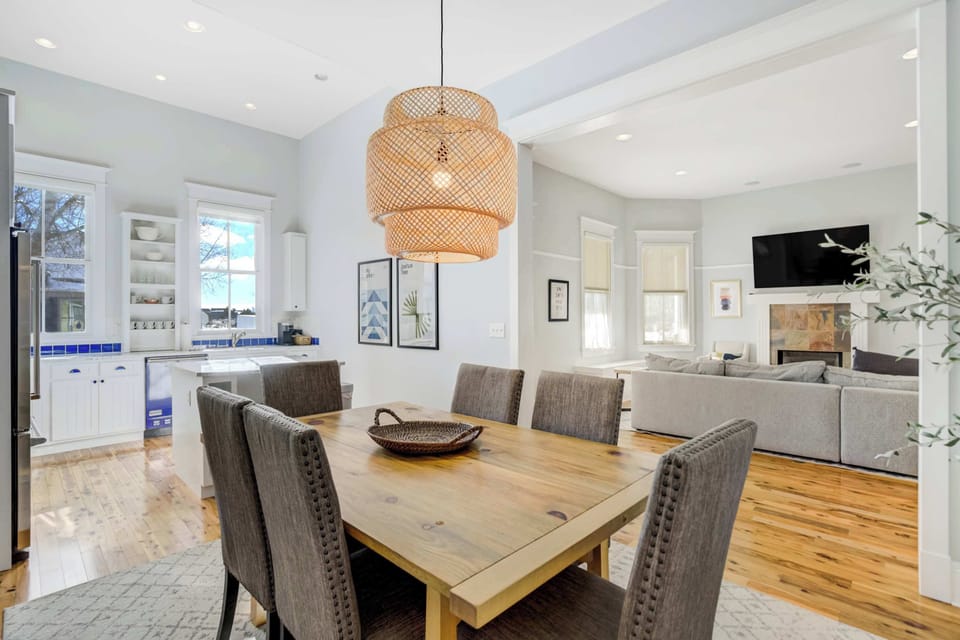 A bright dining space with seating for six sits between the kitchen and living room, creating an easy flow for meals, game nights, and gathering.
