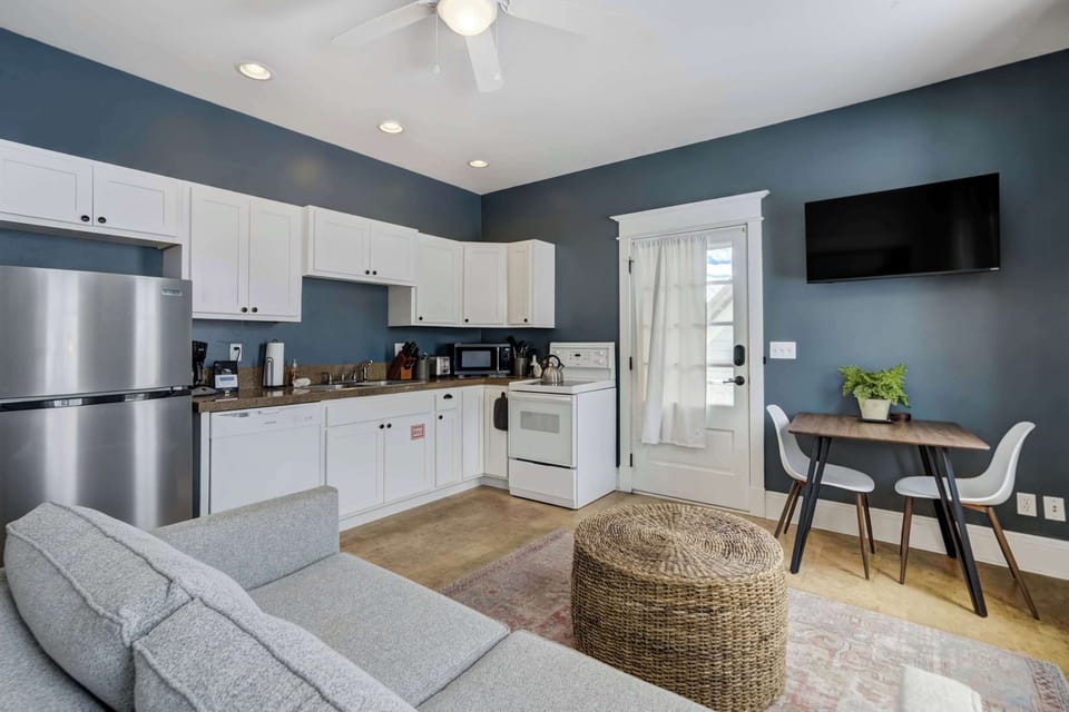 The studio’s open layout brings the kitchen, dining nook, and living area together for a smooth, functional flow. Stainless appliances and clean cabinetry keep the space fresh and modern.