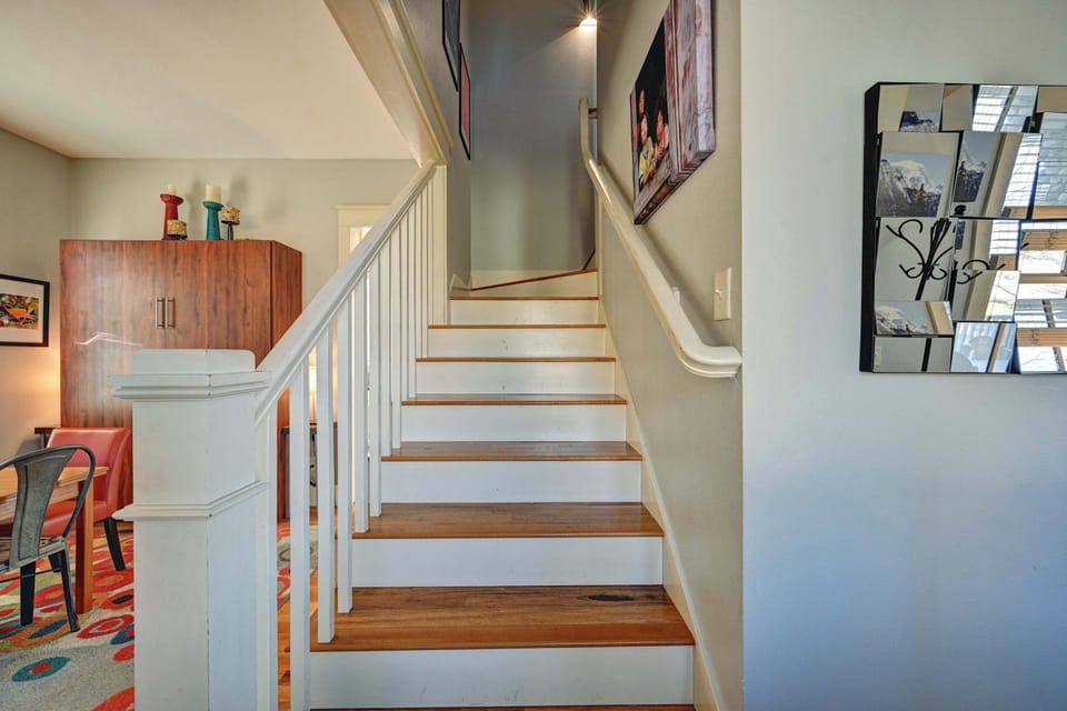 This staircase features sturdy railings, soft lighting, and artwork that adds a personal touch as you head toward the private bedroom level. It connects the main living spaces with a smooth, comfortable flow.