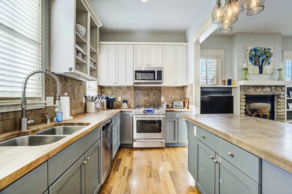 The kitchen offers generous counter space, stainless steel appliances, and open shelving that keeps everything within easy reach. Its bright, functional layout makes meal prep simple whether you're cooking solo or with a group.
