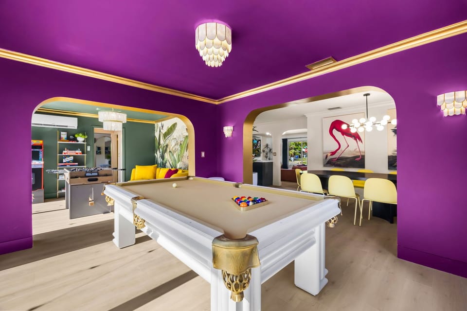 Enjoy a vibrant game of pool in this bold game room that opens seamlessly into the dining and lounge areas!

