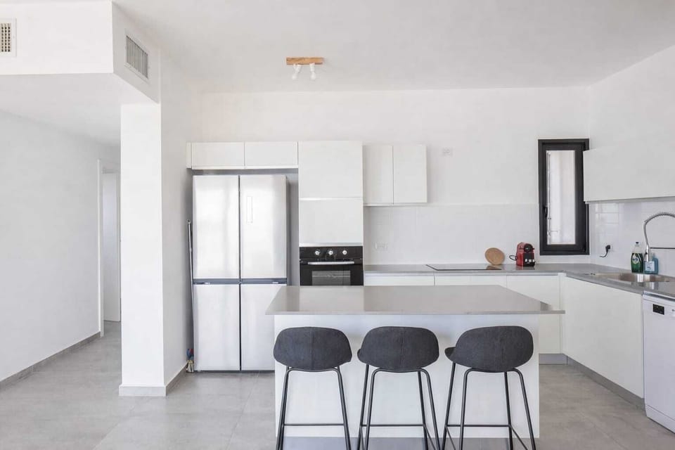 Sleek kitchen island with bar seating invites easy breakfasts, casual conversations, and shared meals together.