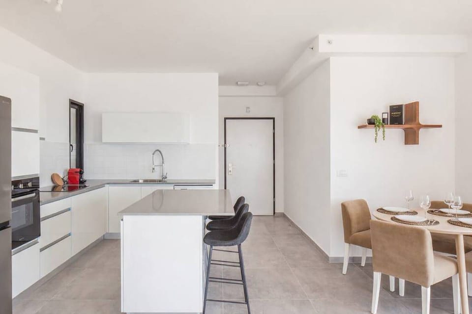 Open kitchen layout with breakfast bar keeps cooking social while staying connected with conversations nearby.