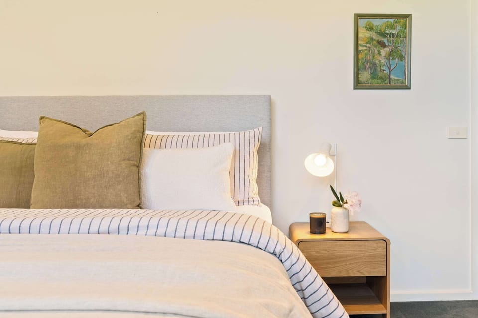 A serene sanctuary with plush bedding and earthy tones, designed to make every night feel like a peaceful escape