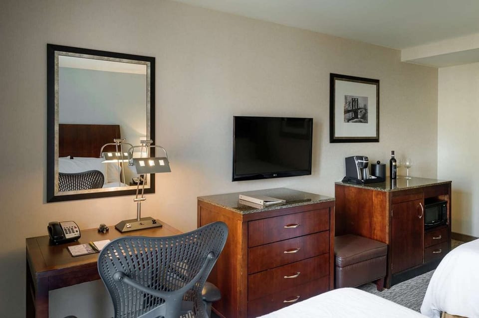 TV, desk, and coffee setup with warm wooden furniture