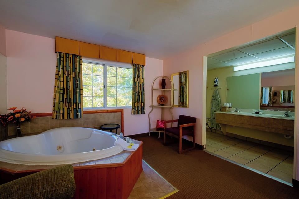 Refresh after a soak with convenient vanity and mirror space.