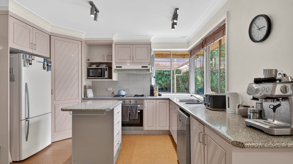 Fresh, light-filled kitchen with ample counter space and modern appliances.