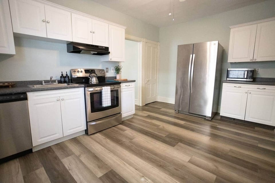 Spacious kitchen with modern appliances and plenty of counter space, stocked with essentials for any length of time. 