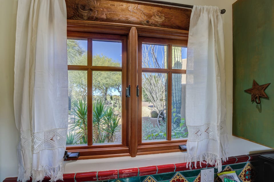 The view from the kitchenette overlooks the parking area and landscaping.