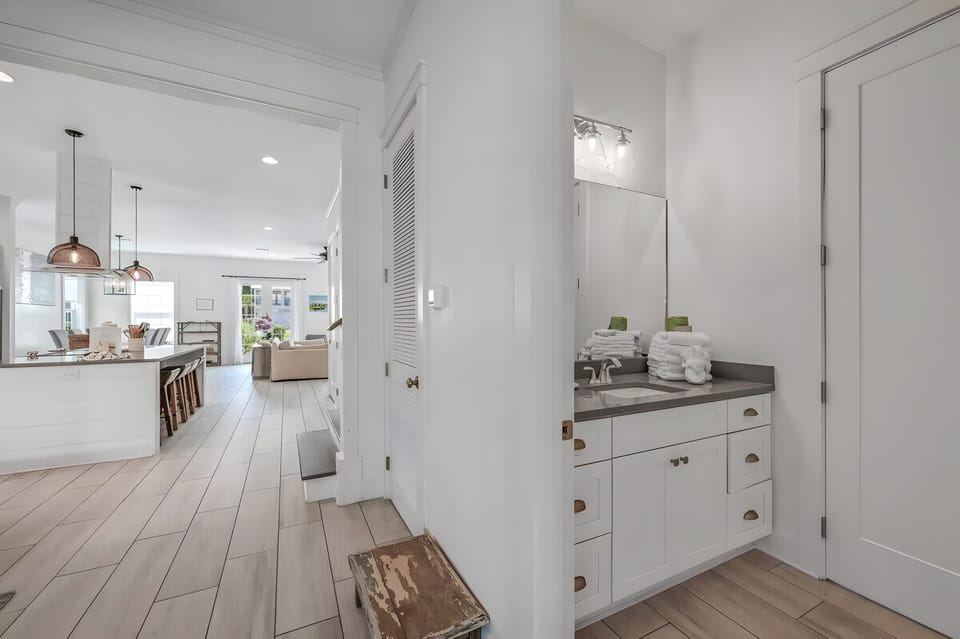 Main hallway bathroom with a sleek vanity and spacious walk-in shower.