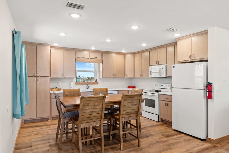 Your spacious kitchen invites you to prepare delicious meals with modern appliances and ample cabinet storage, perfect for family gatherings.