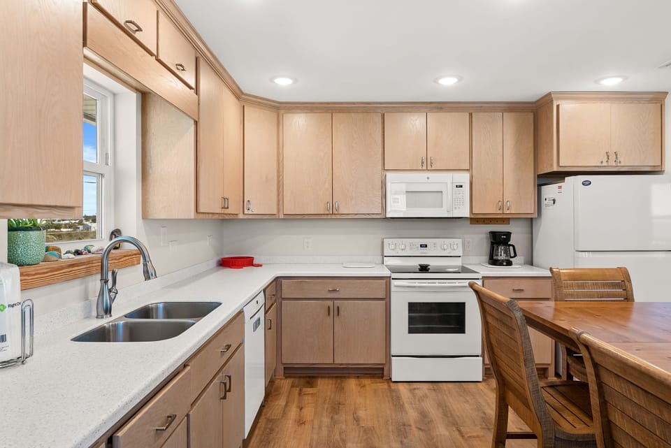 Your fully equipped kitchen invites culinary adventures with ample cabinet storage, modern appliances, and a cozy breakfast nook for morning coffee.