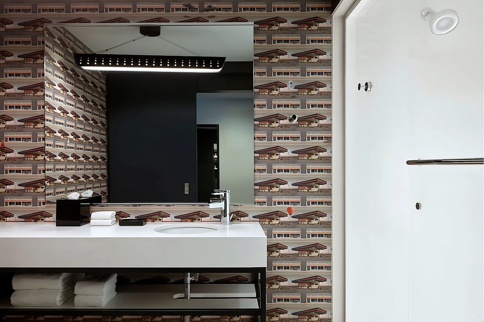Get ready easily with a wide vanity and glowing mirror light.