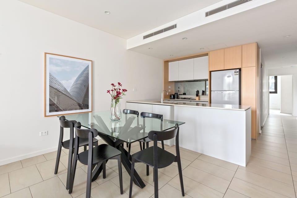 A bright, functional kitchen with modern appliances and a spacious dining setting creates the perfect space to cook, share, and connect.