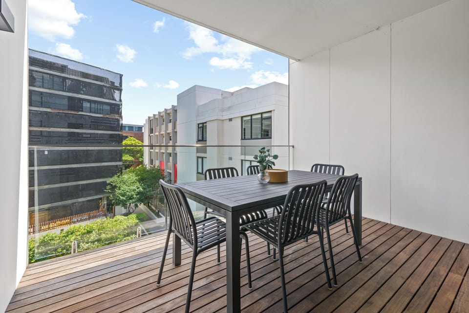 A private balcony with sleek outdoor seating offers a quiet spot to enjoy morning coffee.