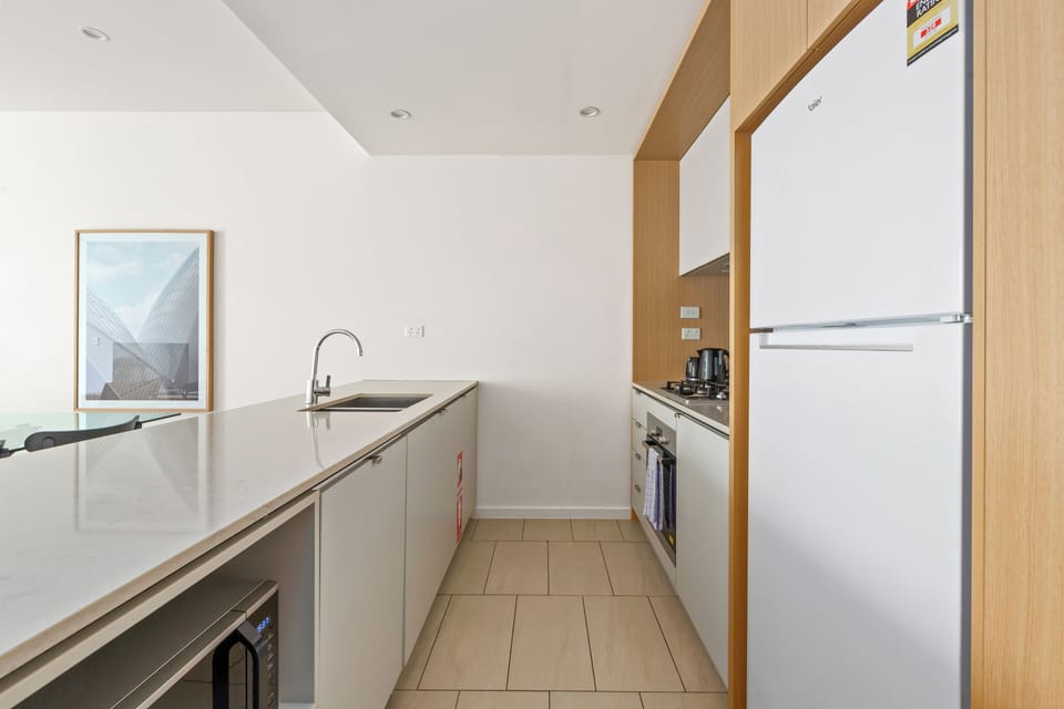 The generous kitchen features ample prep space, an oven, and a dishwasher for easy cleanup.