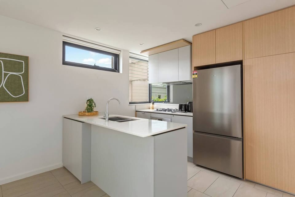 Cook with ease in the first sleek, fully equipped kitchen complete with a full-size fridge, stone benchtops, and stainless-steel appliances.