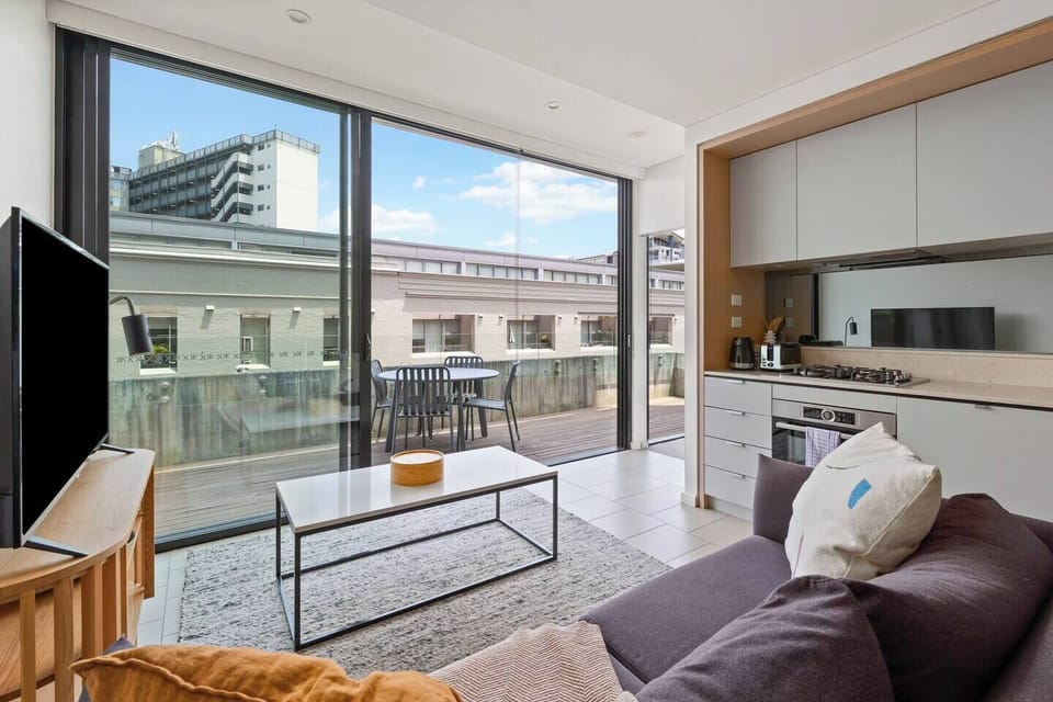 The second sunlit living area opens to the balcony and features comfortable seating, a smart TV, and modern finishes for a cosy, stylish retreat.