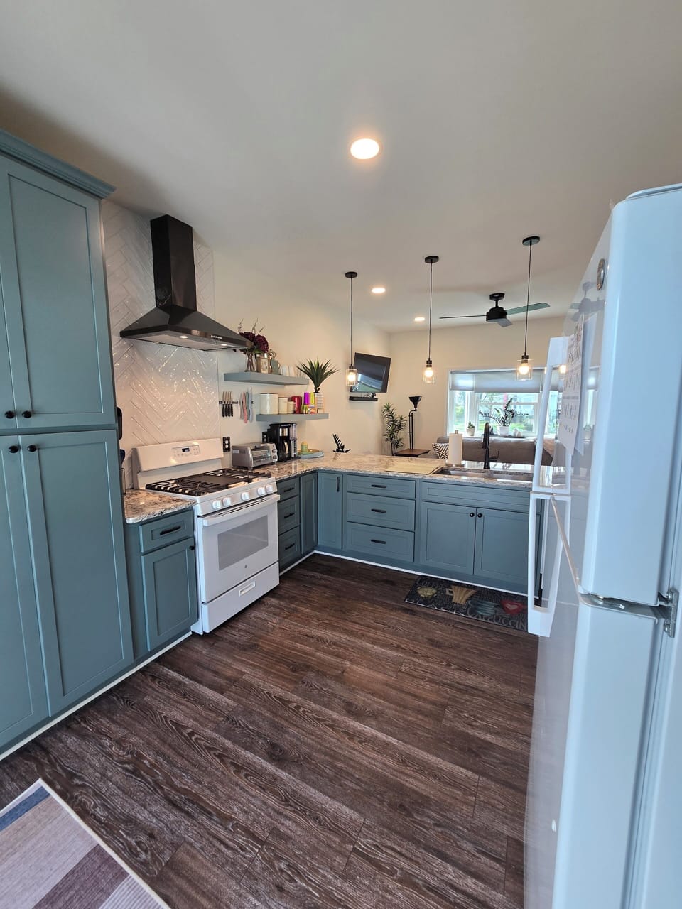 Kitchen with gas stove, frig/freezer, hands free kitchen sink faucet.