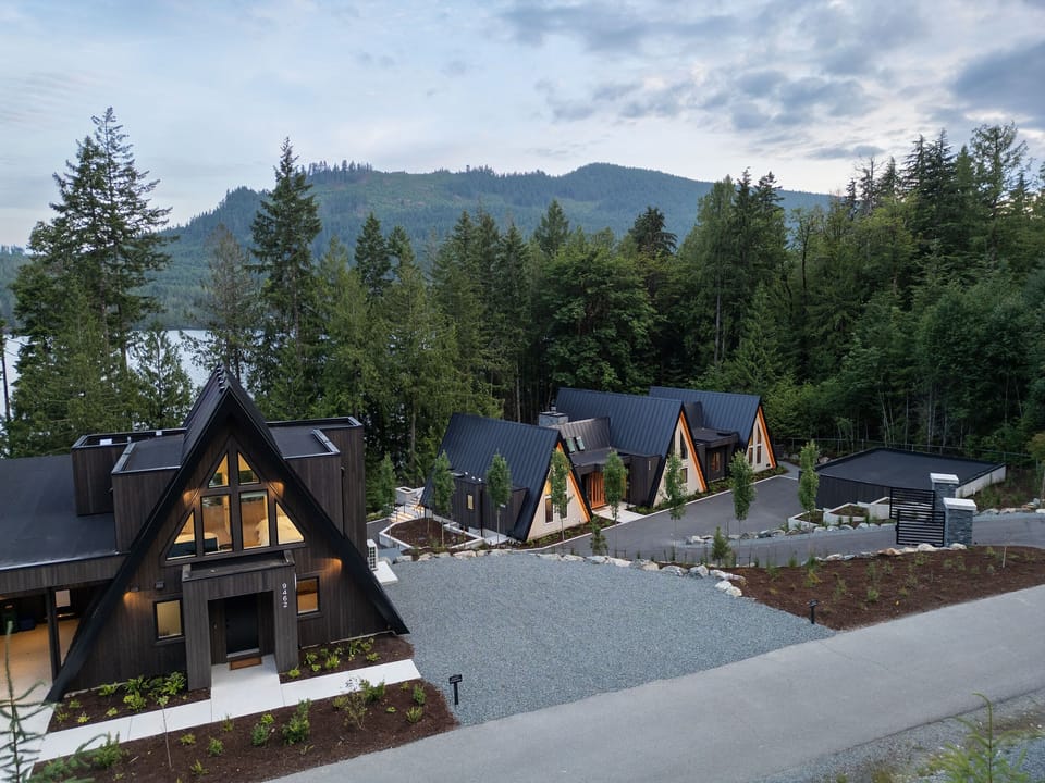 View of one of the cabins (left) and main house (right)