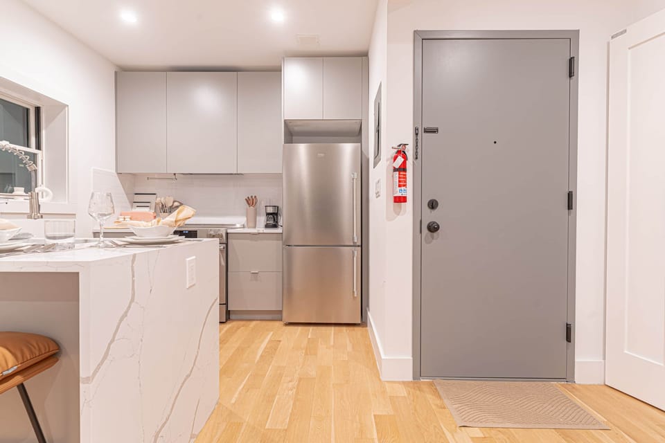 Stainless‑steel appliances, cookware and boho accents make cooking a pleasure.