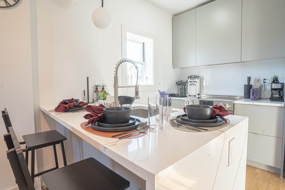 Fully stocked Scandinavian kitchen with cookware, dishes and coffee maker ready for guests