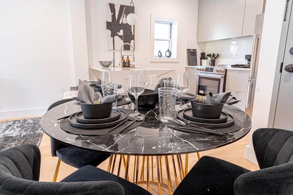 Full dining space with round table, elegant chairs and decorative accents for shared meals