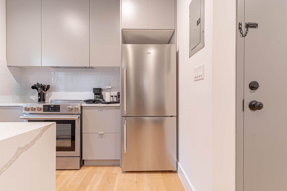 Neatly arranged stainless steel cookware and utensils for convenient home cooking and dining