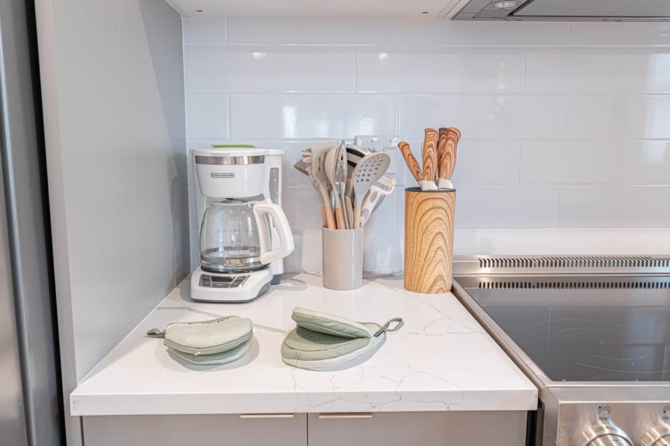 Fully stocked Scandinavian kitchen with cookware, dishes and coffee maker ready for guests