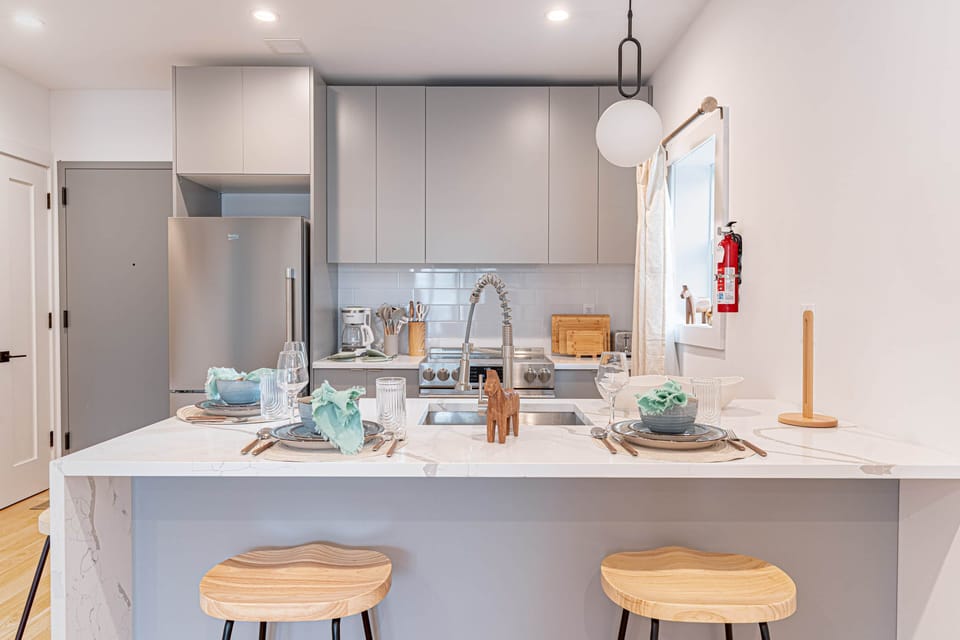 Fully equipped Scandinavian kitchen with stove, fridge and sleek cabinetry in Bushwick